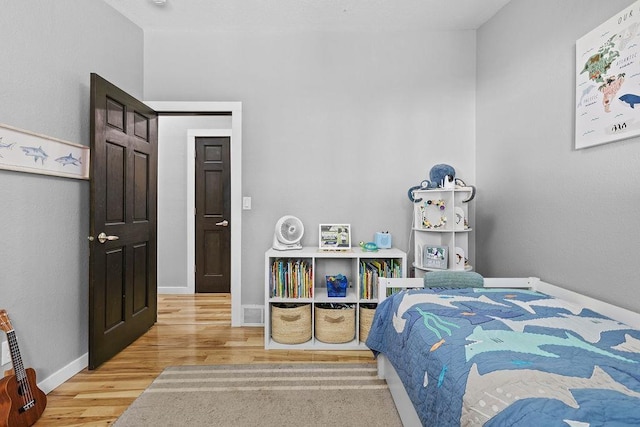 120 25th St, Minot, ND 58701 - bedroom featuring light wood-style floors and baseboards