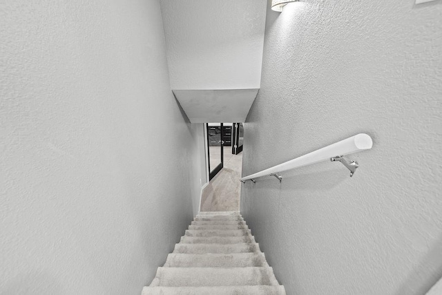 120 25th St, Minot, ND 58701 - staircase with a textured wall