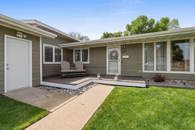 120 25th St, Minot, ND 58701 - property entrance with a wooden deck and a yard