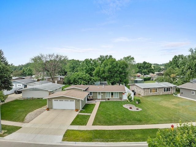 120 25th St, Minot, ND 58701 - ranch-style home featuring a front yard, a garage, concrete driveway, and a residential view