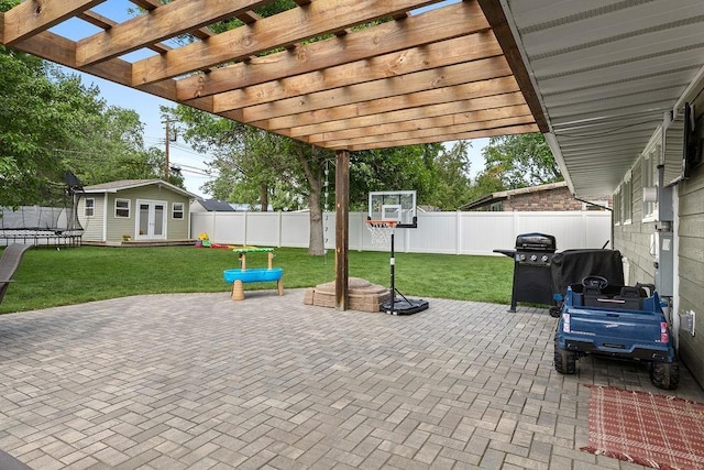 120 25th St, Minot, ND 58701 - fenced backyard featuring a trampoline, an outbuilding, a patio, and grilling area