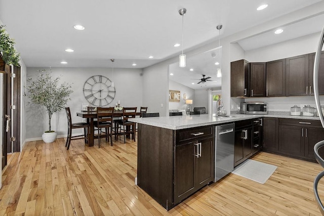 120 25th St, Minot, ND 58701 - kitchen with appliances with stainless steel finishes, dark brown cabinets, light wood-style flooring, and recessed lighting