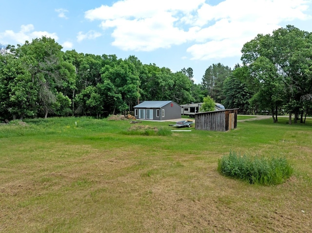 4706 SE 37th St, Minot, ND 58701 - view of green lawn with a wooded view