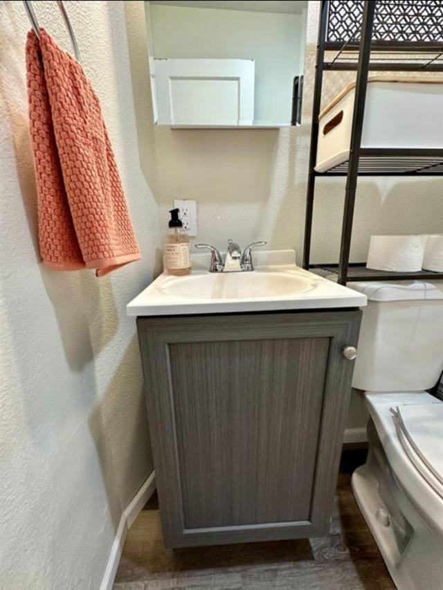 607 Main St, Minot, ND 58701 - bathroom with vanity and a textured wall