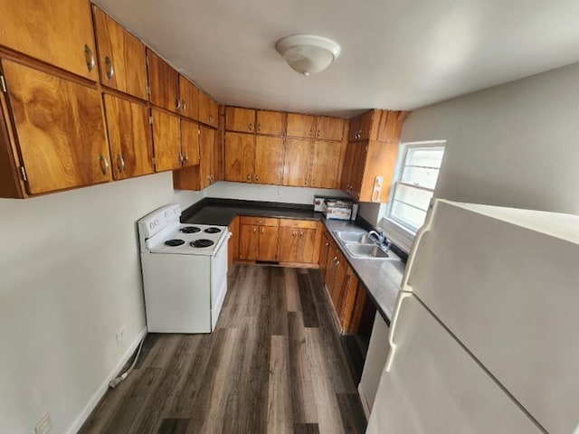 607 Main St, Minot, ND 58701 - kitchen with white appliances, brown cabinets, and dark wood-style floors
