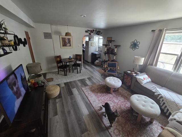 607 Main St, Minot, ND 58701 - living area with wood finished floors and arched walkways