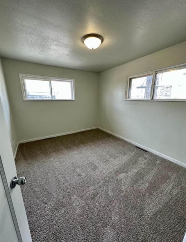 607 Main St, Minot, ND 58701 - carpeted spare room featuring a textured ceiling
