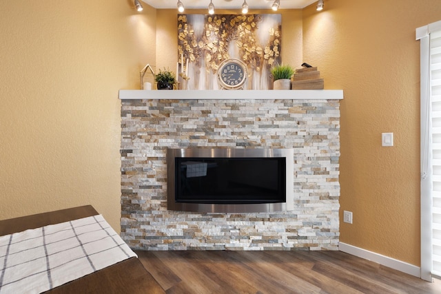 4007 Crossing St, Minot, ND 58701 - detailed view of rail lighting, wood finished floors, and a textured wall