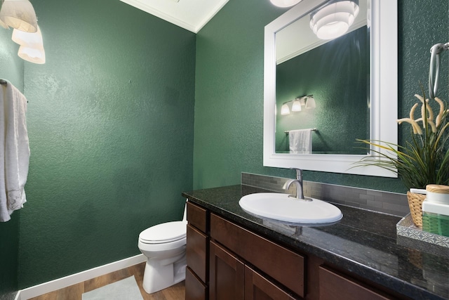 4007 Crossing St, Minot, ND 58701 - half bathroom featuring wood finished floors, vanity, and a textured wall