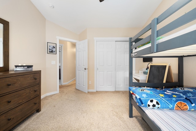 4007 Crossing St, Minot, ND 58701 - bedroom with light colored carpet, a closet, and vaulted ceiling