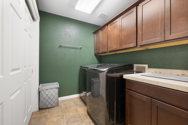4007 Crossing St, Minot, ND 58701 - washroom with cabinet space, a textured wall, and separate washer and dryer
