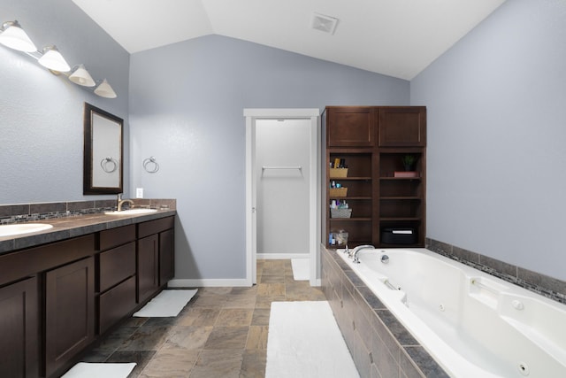 4007 Crossing St, Minot, ND 58701 - bathroom with a whirlpool tub, double vanity, and vaulted ceiling