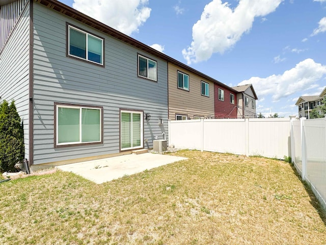4007 Crossing St, Minot, ND 58701 - rear view of house with a fenced backyard and a patio area