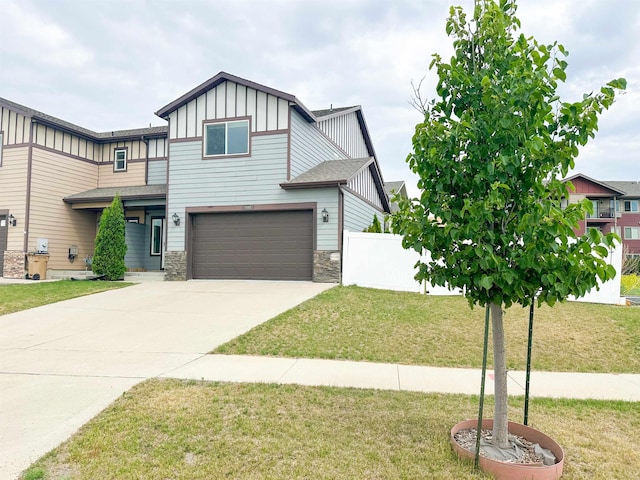 4007 Crossing St, Minot, ND 58701 - view of front facade with board and batten siding, stone siding, an attached garage, and concrete driveway