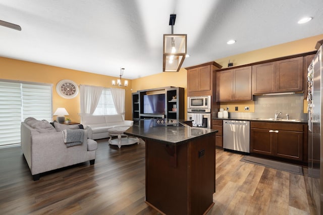4007 Crossing St, Minot, ND 58701 - kitchen featuring appliances with stainless steel finishes, a chandelier, open floor plan, dark wood-type flooring, and hanging light fixtures