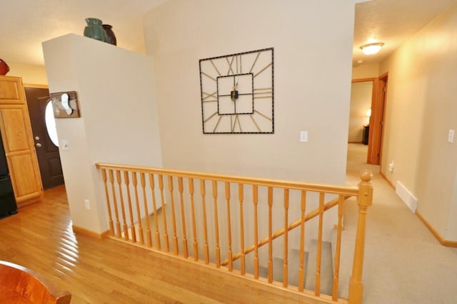 2033 14th St, Minot, ND 58703 - hallway featuring an upstairs landing and wood finished floors