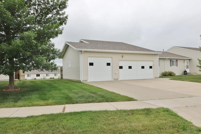 2033 14th St, Minot, ND 58703 - view of front of home with concrete driveway, a front lawn, and a garage