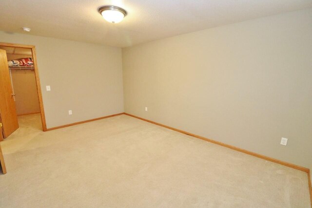 2033 14th St, Minot, ND 58703 - unfurnished room featuring light colored carpet and a smoke detector