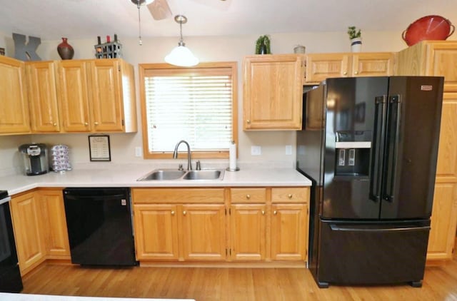 2033 14th St, Minot, ND 58703 - kitchen with black appliances, light countertops, light wood-type flooring, and a ceiling fan