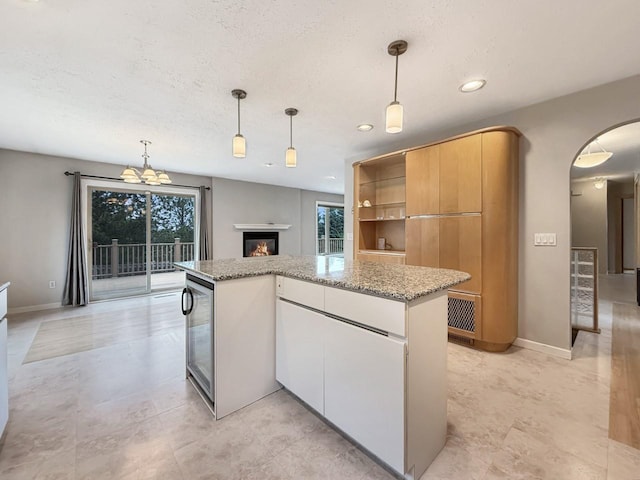1434 10th St, Minot, ND 58701 - kitchen with healthy amount of natural light, wine cooler, a center island, pendant lighting, and recessed lighting