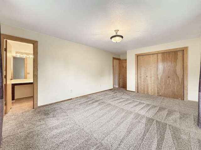 1434 10th St, Minot, ND 58701 - unfurnished bedroom featuring carpet flooring, a closet, and ensuite bath
