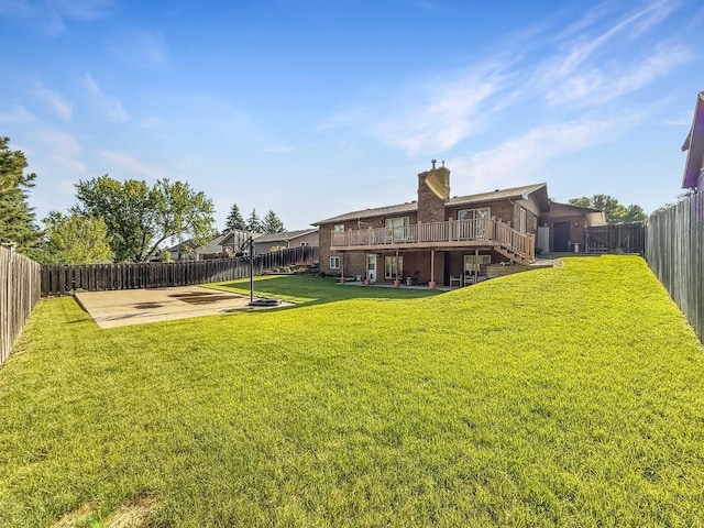 1434 10th St, Minot, ND 58701 - fenced backyard with stairs, a patio area, and a wooden deck