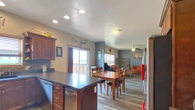 1170 170th St NW, Des Lacs, ND 58733 - kitchen with appliances with stainless steel finishes, a peninsula, open floor plan, recessed lighting, and light wood-style floors