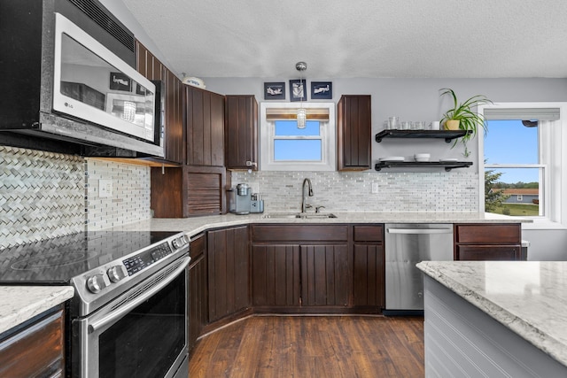 4610 12d St NW, Garrison, ND 58540 - kitchen with stainless steel appliances, a textured ceiling, dark wood-style floors, dark brown cabinets, and tasteful backsplash