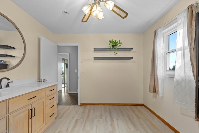 4610 12d St NW, Garrison, ND 58540 - bathroom featuring wood finished floors, vanity, and ceiling fan
