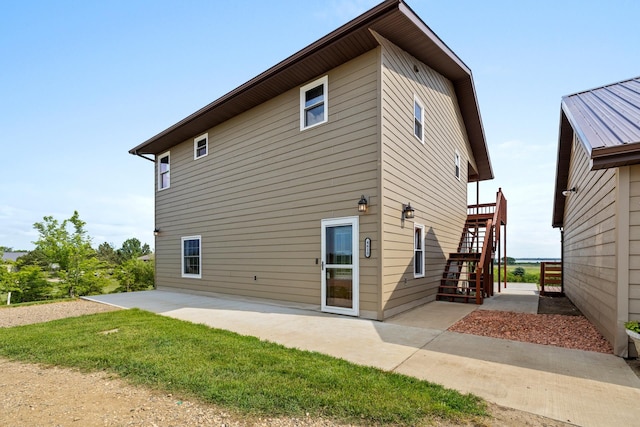 4610 12d St NW, Garrison, ND 58540 - back of property featuring stairs and a patio