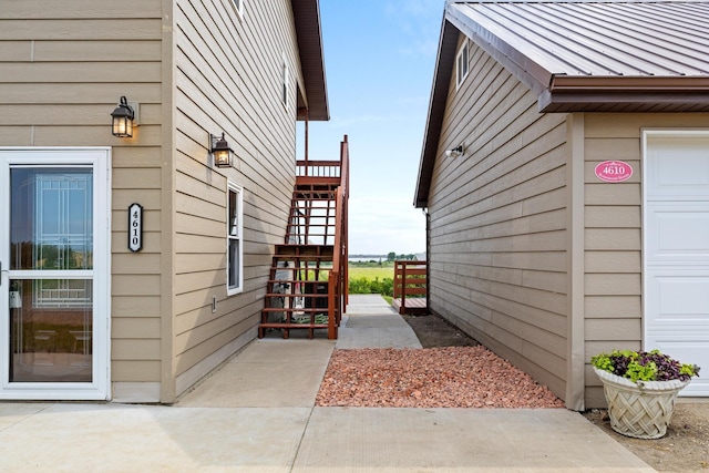 4610 12d St NW, Garrison, ND 58540 - view of side of property with stairs, a metal roof, and a standing seam roof