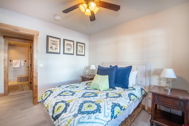 bedroom featuring ensuite bath, ceiling fan, and light wood-type flooring