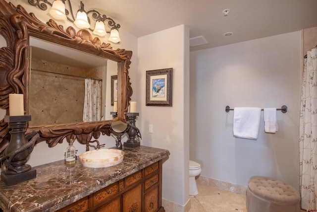 bathroom with vanity, tile floors, and toilet