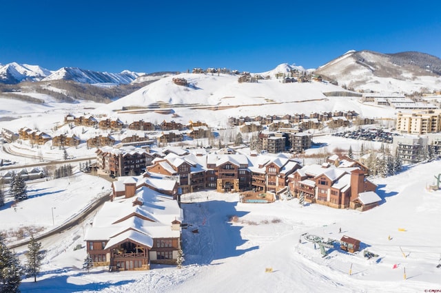 snowy aerial view featuring a mountain view