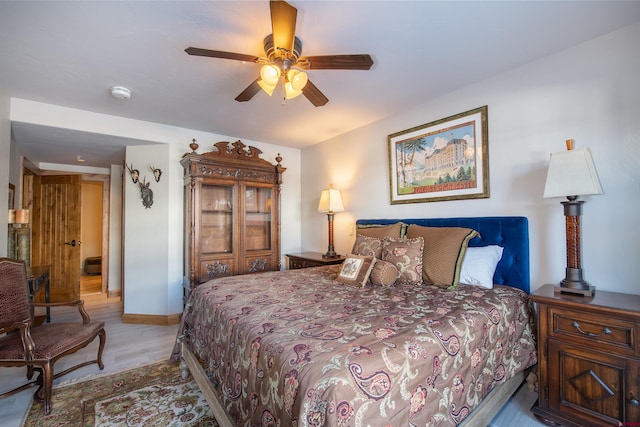 bedroom with ceiling fan and light wood-type flooring