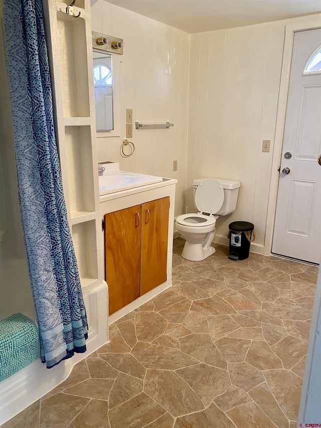 full bathroom featuring shower / bath combination with curtain, toilet, and vanity