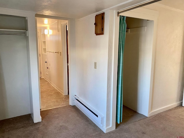 hallway with crown molding, carpet flooring, and a baseboard radiator