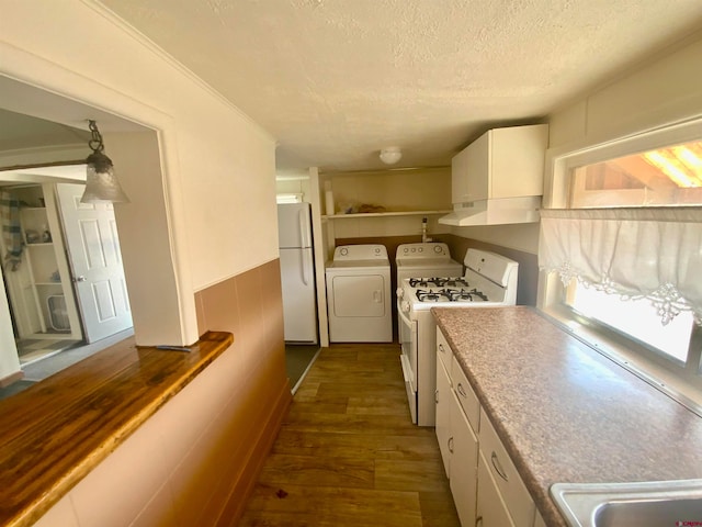 kitchen with white fridge, washer and clothes dryer, white cabinets, a textured ceiling, and dark hardwood / wood-style flooring