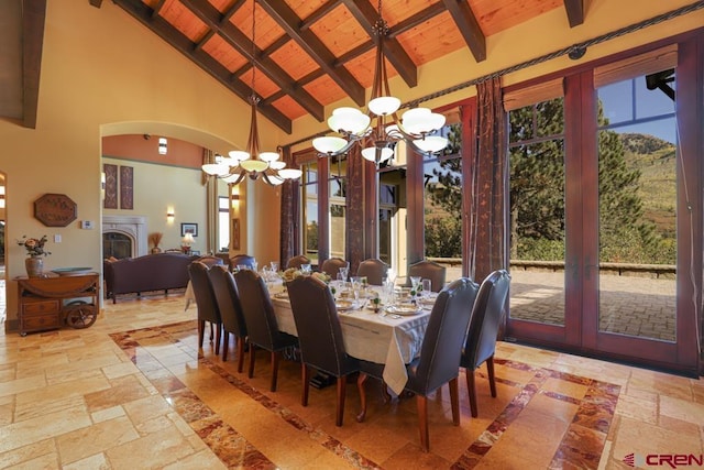 tiled dining space with wood ceiling, a notable chandelier, beamed ceiling, and high vaulted ceiling