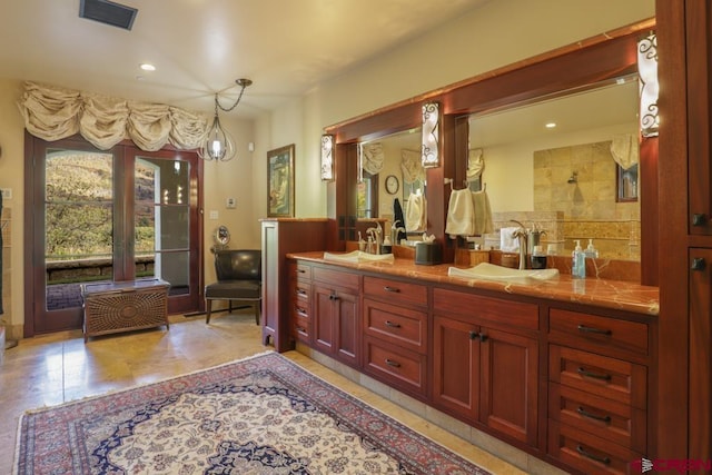 bathroom featuring dual bowl vanity, tile floors, and an inviting chandelier