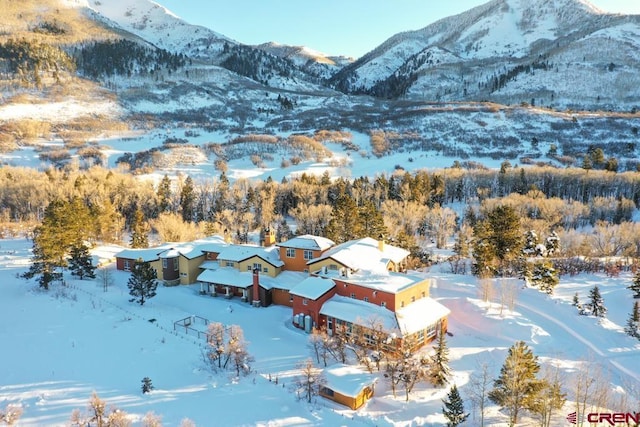 snowy aerial view with a mountain view