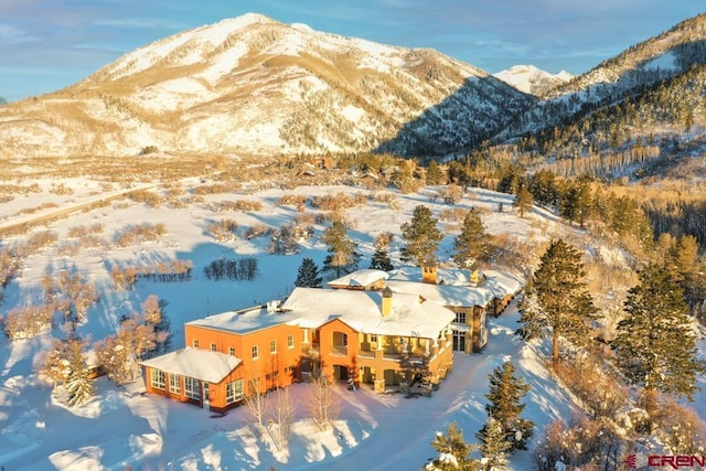 snowy aerial view with a mountain view