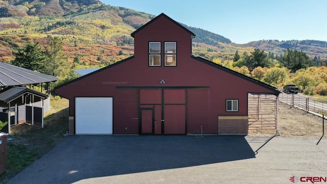 view of front of home with a mountain view and a garage