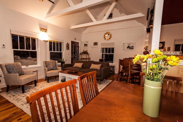 interior space featuring high vaulted ceiling, dark wood-type flooring, and beamed ceiling