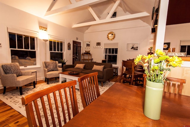 interior space with hardwood / wood-style floors, high vaulted ceiling, and beamed ceiling