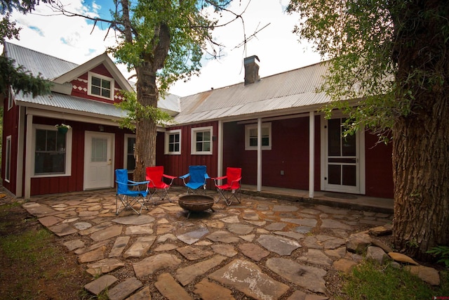 back of house featuring a patio and an outdoor fire pit