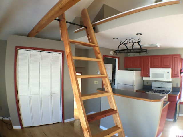 kitchen featuring white appliances and light hardwood / wood-style floors