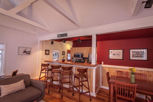 interior space featuring range, refrigerator, dark hardwood / wood-style floors, and kitchen peninsula