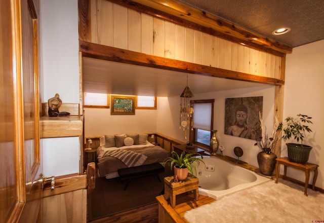 bedroom featuring dark hardwood / wood-style flooring and a textured ceiling