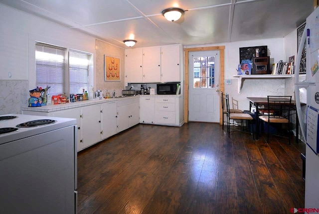 kitchen featuring electric stove, white cabinets, and dark hardwood / wood-style floors